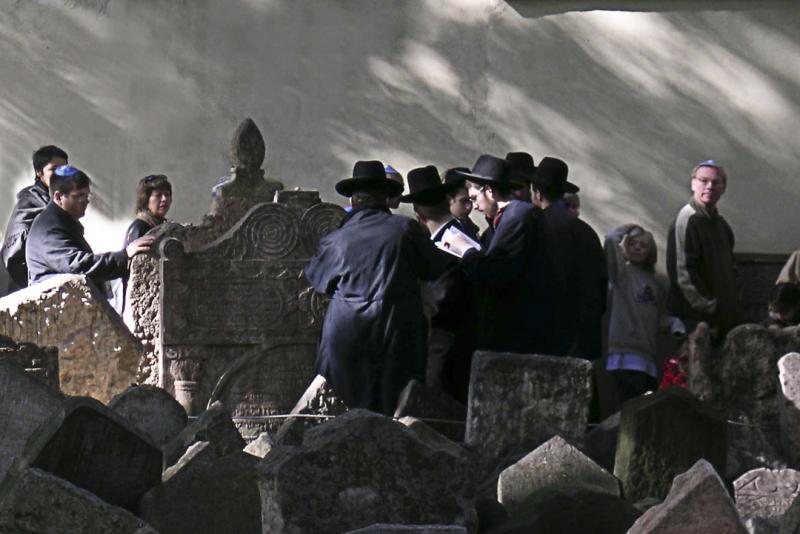 Prayers for a revered rabbi in the Jewish cemetery in Prague - UNTITLED ©2004 Martin Oretsky